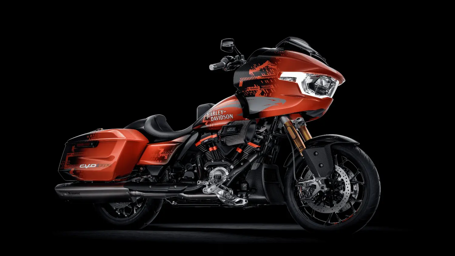 An orange 2025 Harley-Davidson® CVO™ Road Glide® RR motorcycle displayed against a sleek black background in Stuart, FL.