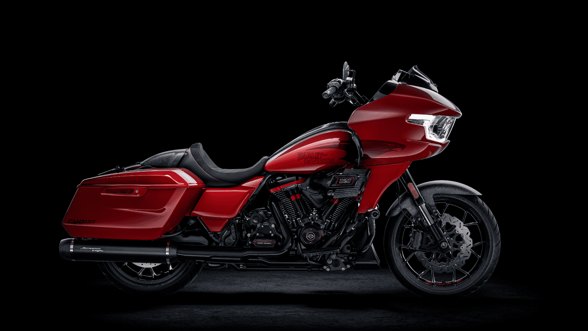 A red 2025 Harley-Davidson® CVO™ Road Glide® ST motorcycle displayed against a sleek black background in Stuart, FL. Available in Treasure Coast Harley-Davidson®
