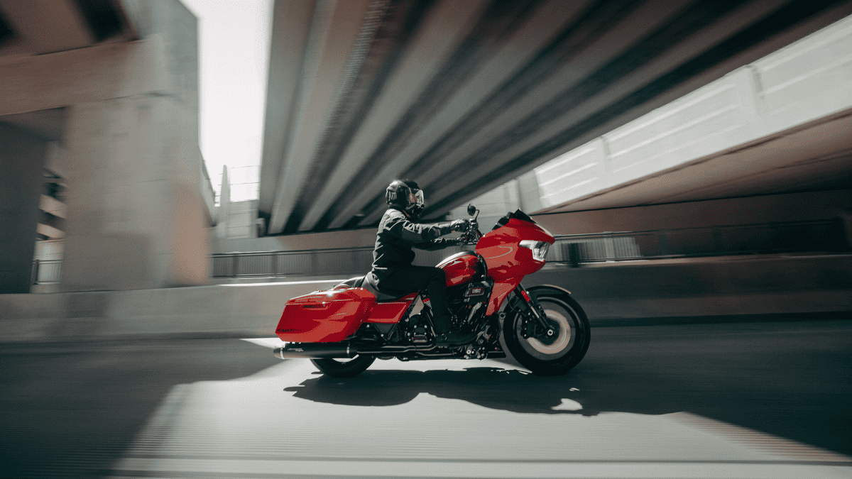 2025 Harley-Davidson® CVO™ Road Glide® ST riding through an urban West Palm Beach FL underpass with aggressive red styling and performance touring features