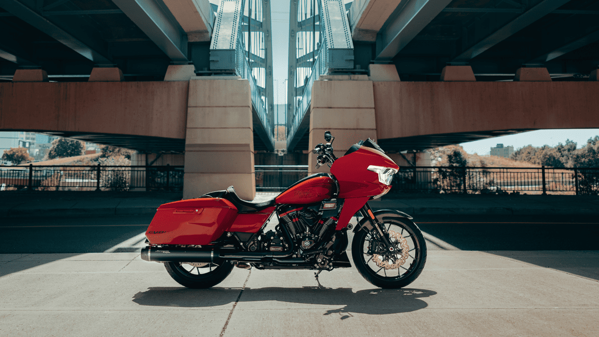 2025 Harley-Davidson® CVO™ Road Glide® ST in red parked beneath an urban bridge near Orlando, FL—performance and style meet
