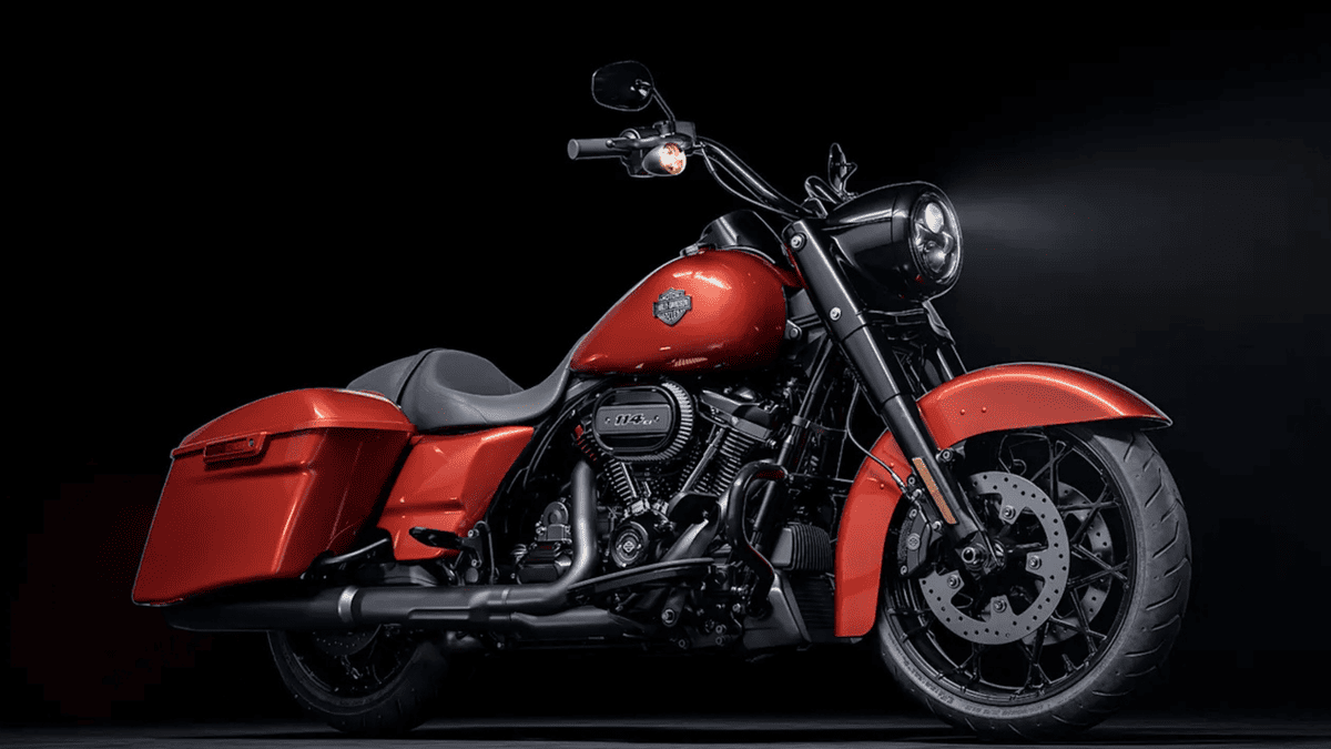 2025 Harley-Davidson® Road King® Special in red and black on display with a spotlight, emphasizing its custom bagger styling and powerful Milwaukee-Eight® 114 engine.
