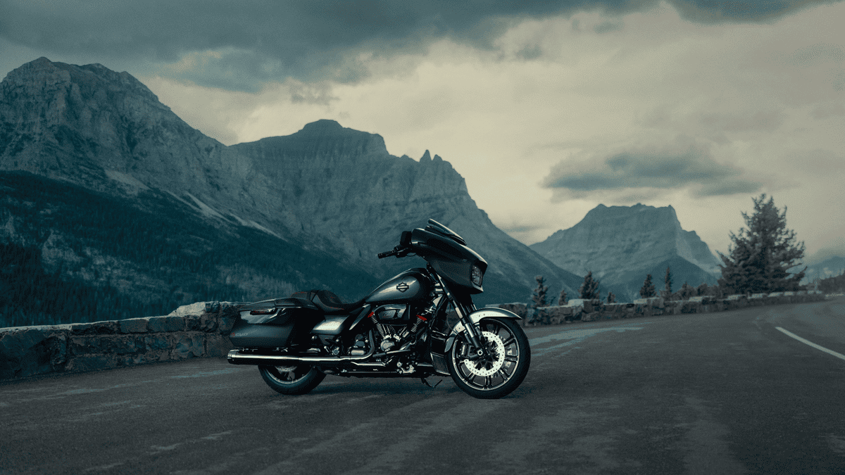 2025 Harley-Davidson® CVO™ Street Glide® near Sanford, FL parked on a scenic mountain road, showcasing its sleek touring design.