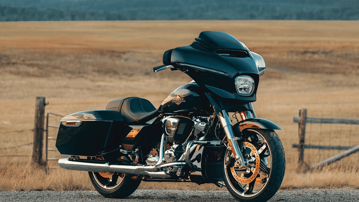 2025 Harley-Davidson® Street Glide® in black with chrome accents, resting on a country road—ideal for veteran Sanford riders seeking touring comfort.