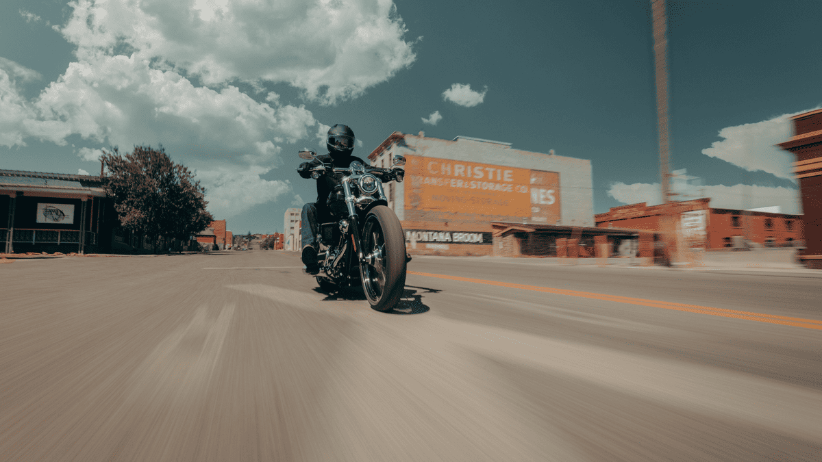 2025 Harley-Davidson® Breakout® delivering raw power and bold styling on an open city street near Sanford under a clear sky.
