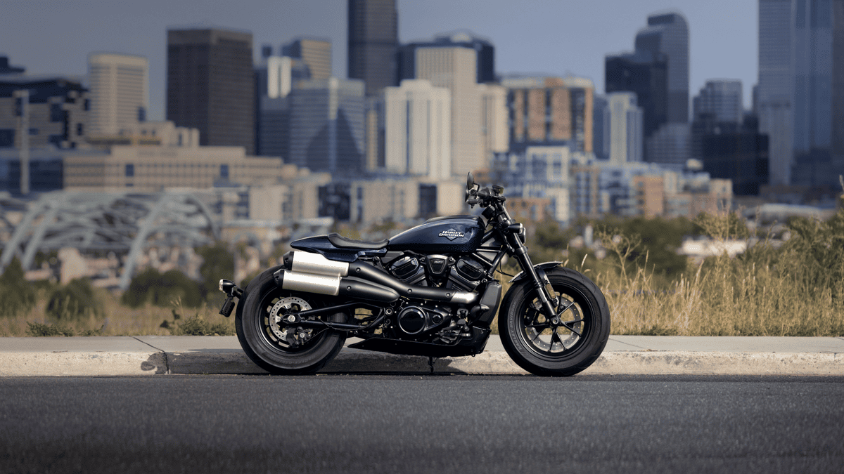 Side view of the 2025 Harley-Davidson® Sportster® S near Palm Bay, FL, with the city skyline in the background highlighting its aggressive stance.