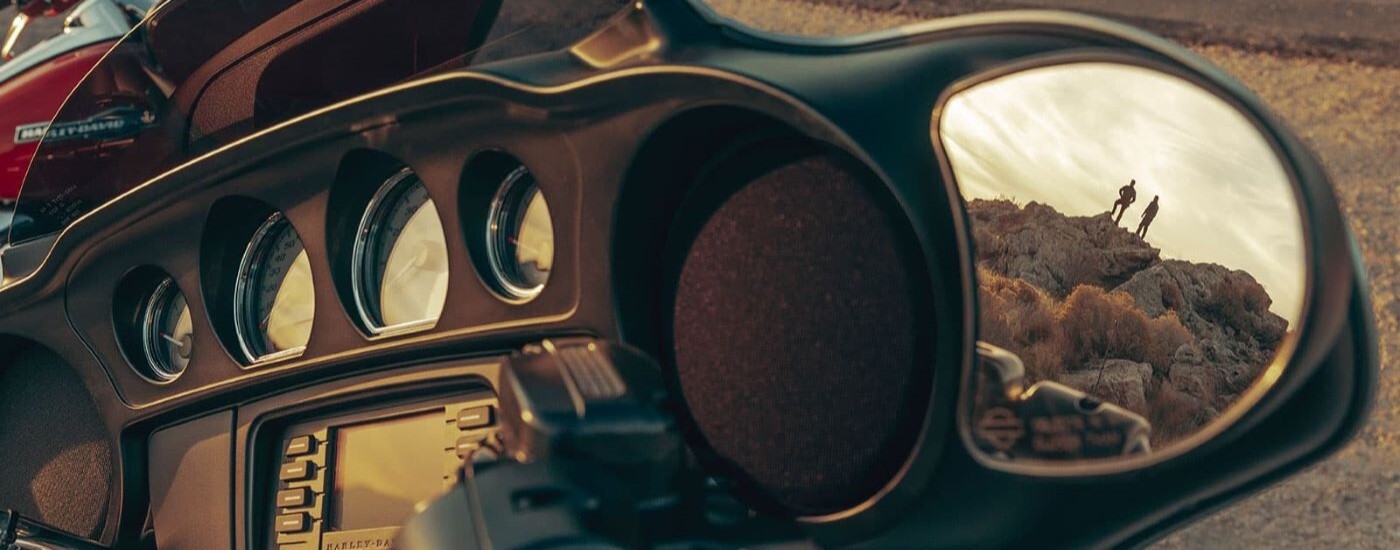 A close up shows the mirror on a black 2023 Harley-Davidson Street Glide.