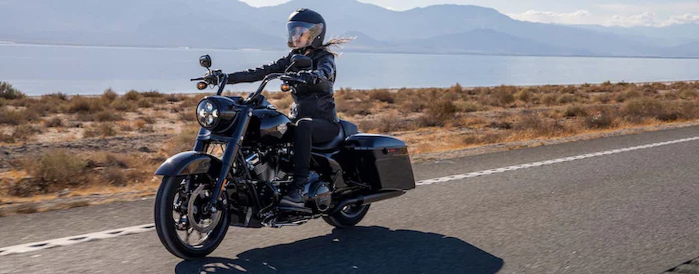 A person is shown riding a black 2022 Harley-Davidson Road-King Special.