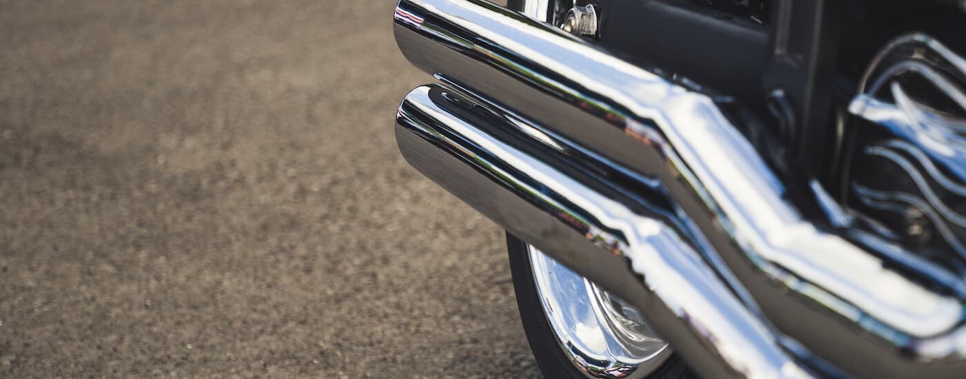 A close up of an exhaust at a used motorcycle dealer is shown.