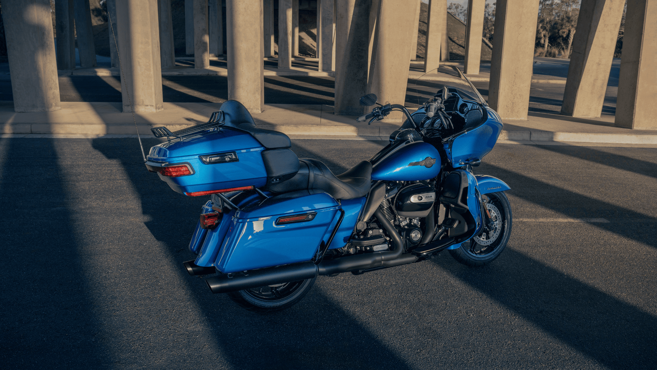 Blue Harley-Davidson Road Glide Limited motorcycle parked under an overpass.