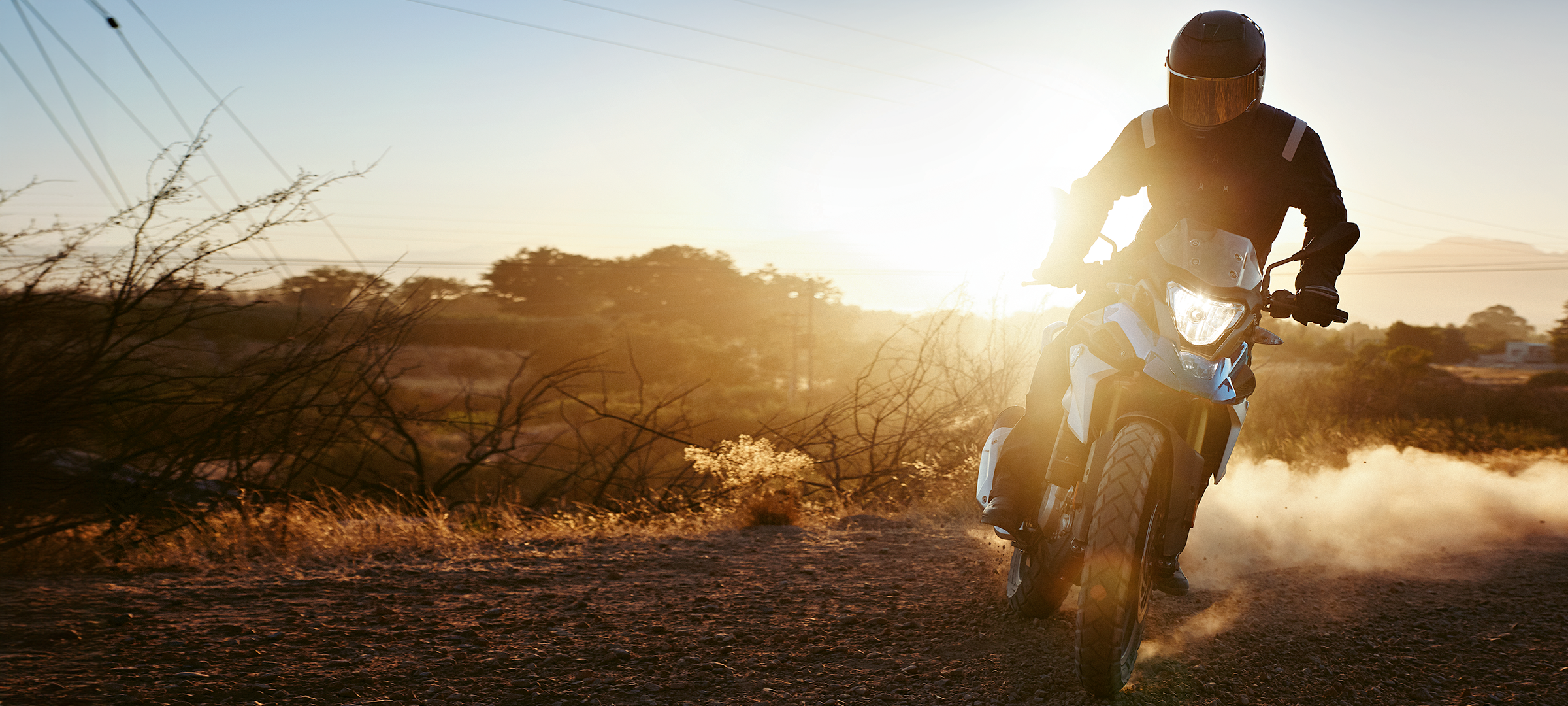 Man riding KTM motorcycle up a hill