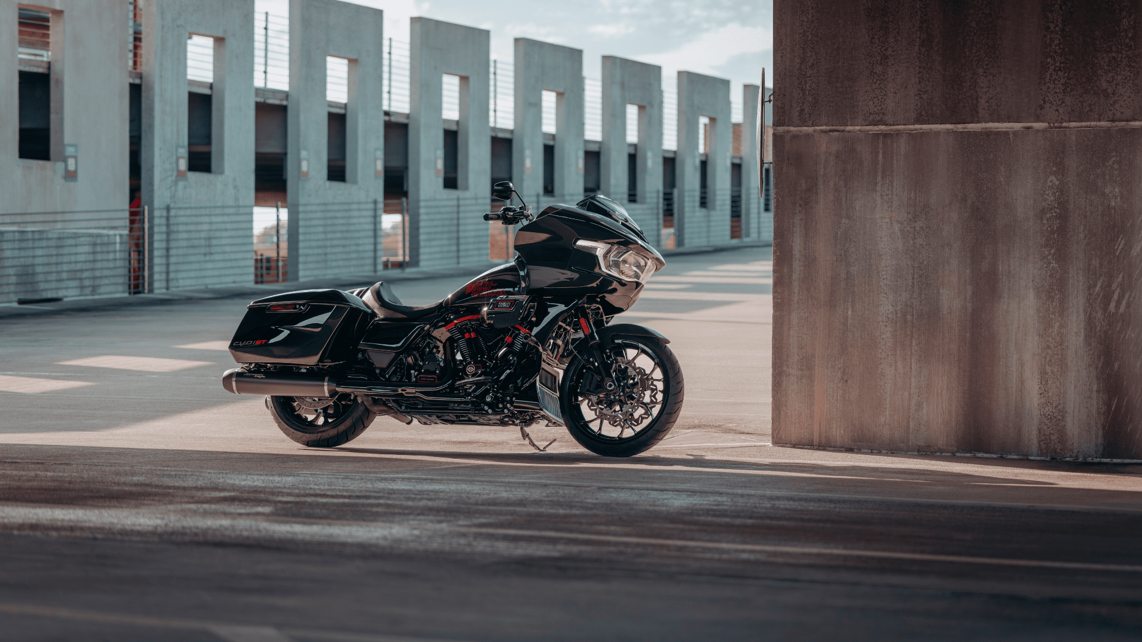 2024 CVO™ Road Glide® ST motorcycle parked in an urban setting with modern architecture