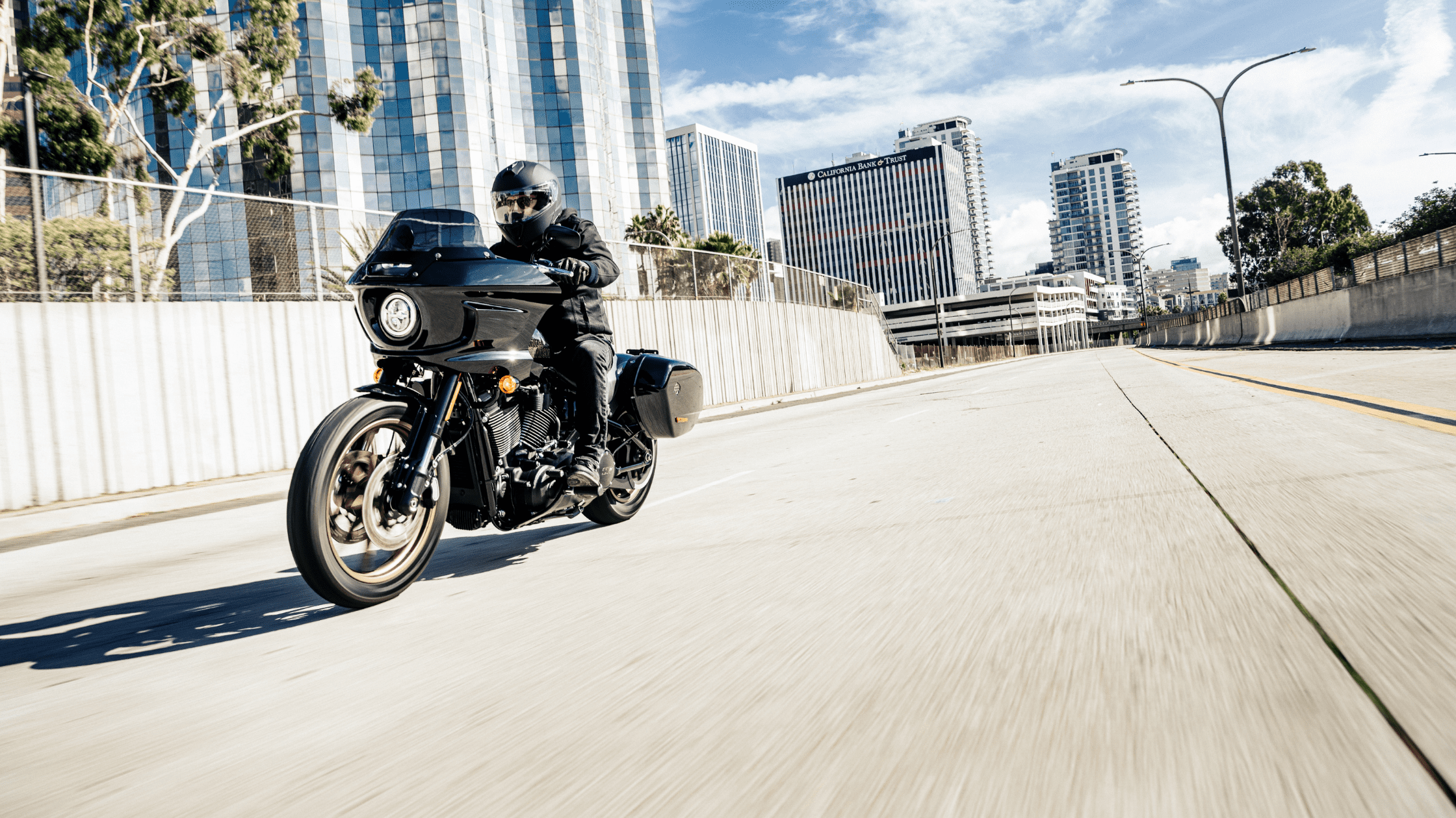 2024 Harley-Davidson® Low Rider® ST on the road with buildings at the background