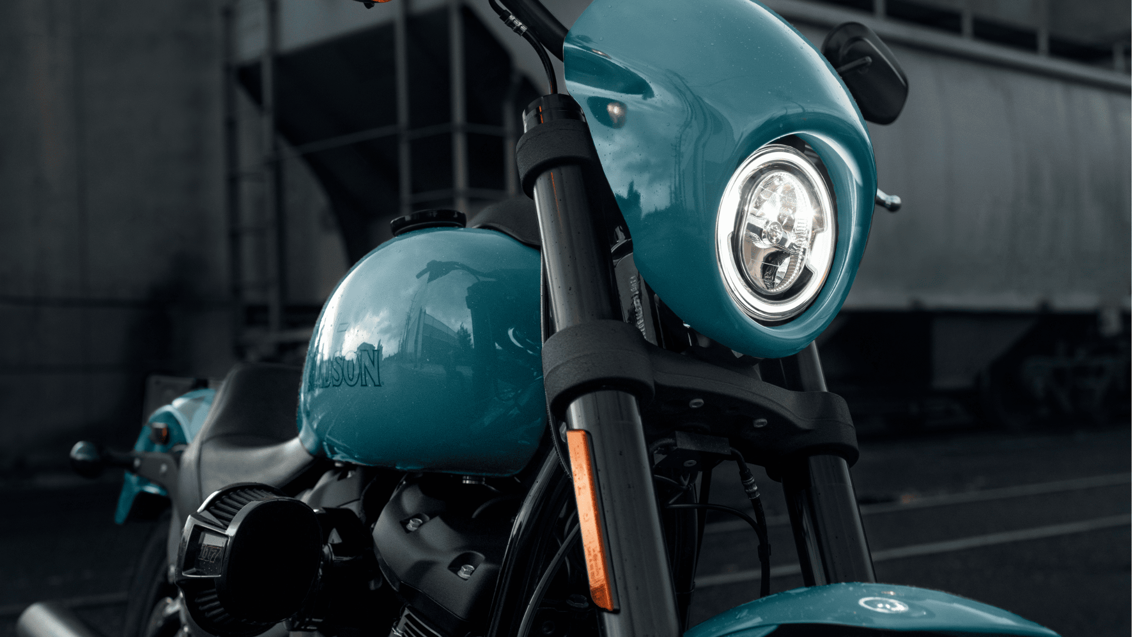 Close-up of Harley-Davidson Low Rider® S headlight and tank in a striking teal color