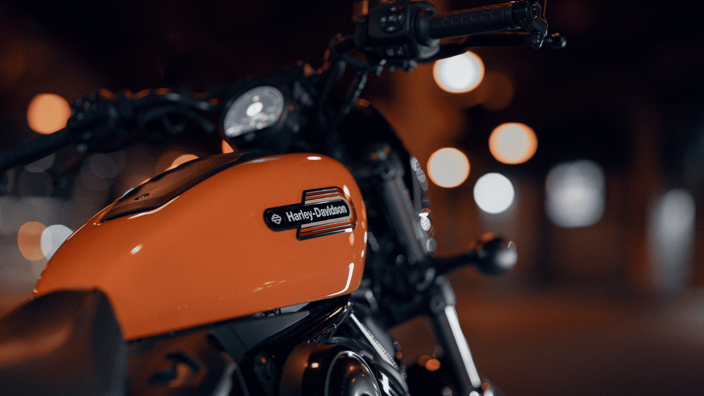 Close-up of a 2024 Harley-Davidson® Nightster® Special's orange tank with the logo