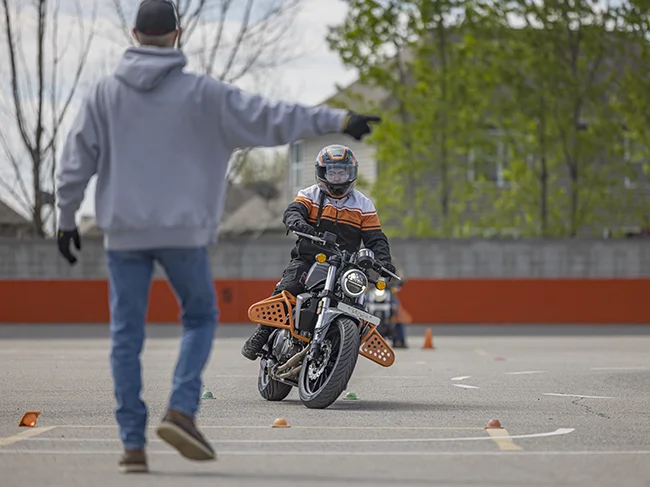 class instructor directing a student rider to turn