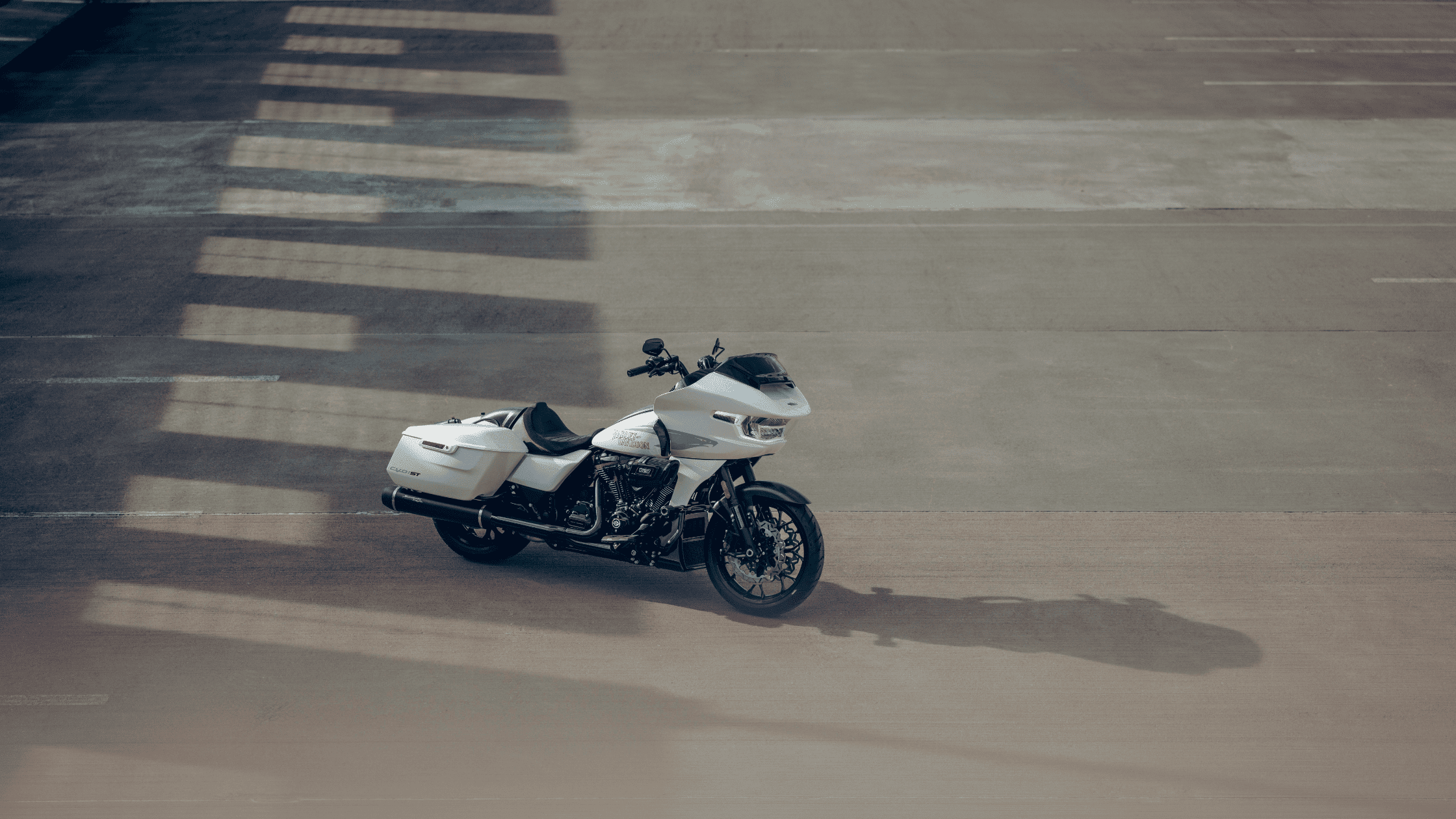 2024 Harley-Davidson® CVO™ Road Glide® ST parked in a sunlit area, showcasing premium style.