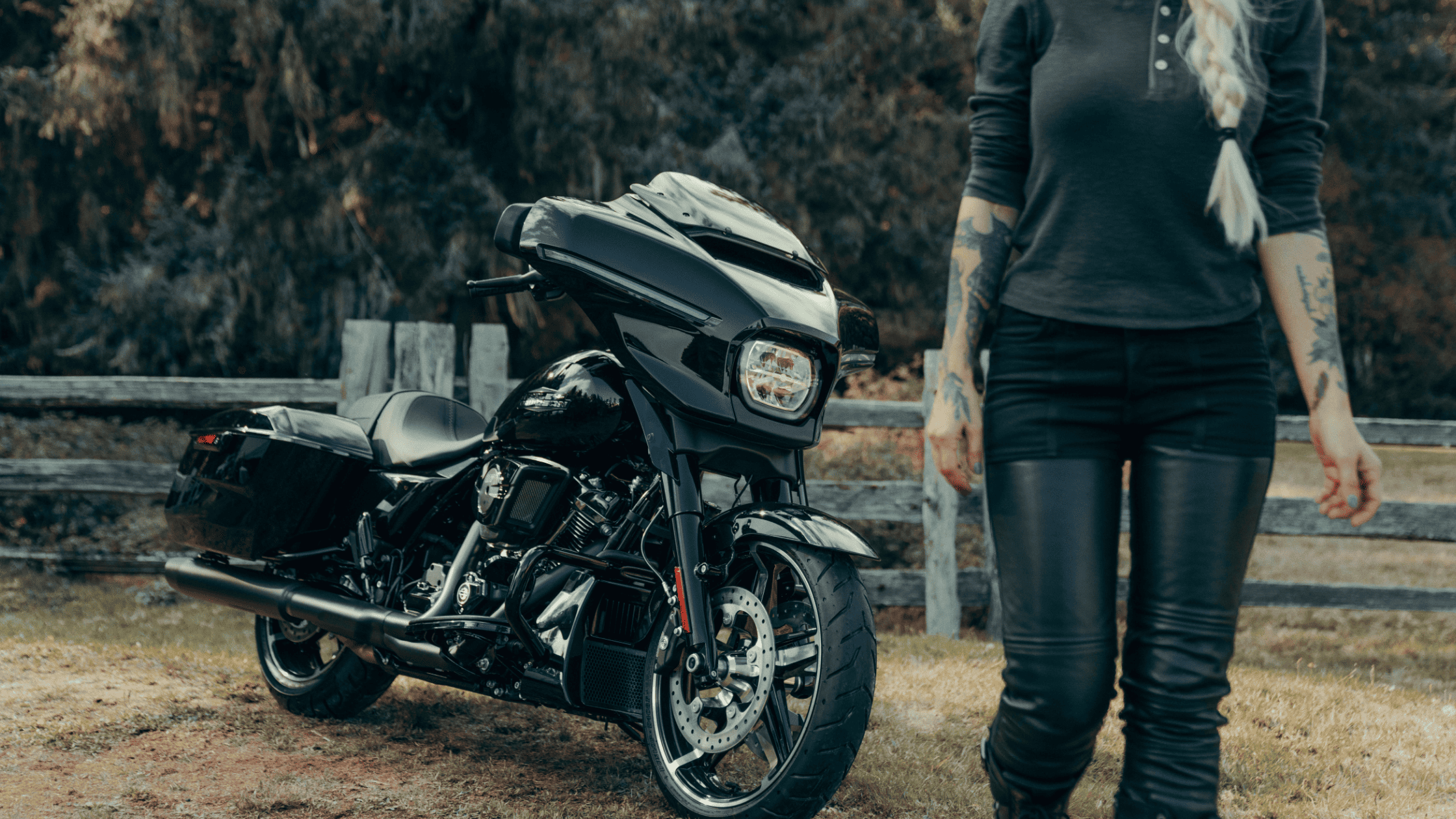 2024 Harley-Davidson® Street Glide® parked in a rustic setting, showcasing its sleek and powerful design.