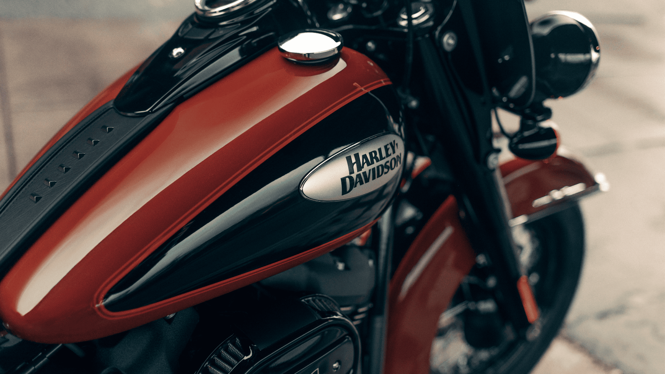 Close-up of a red and black Harley-Davidson® Heritage Classic fuel tank showcasing the iconic Harley-Davidson® logo.