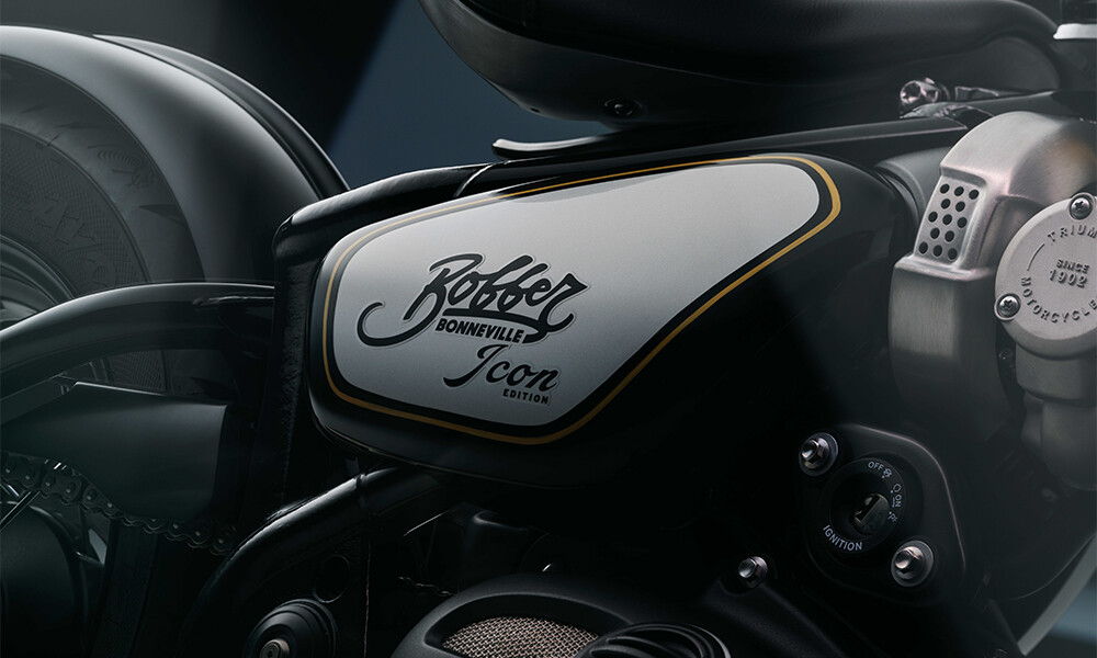 A close up side shot of the Black Sapphire Bonneville Bobber side wing with Bobber Bonneville Icon Edition in black script writing