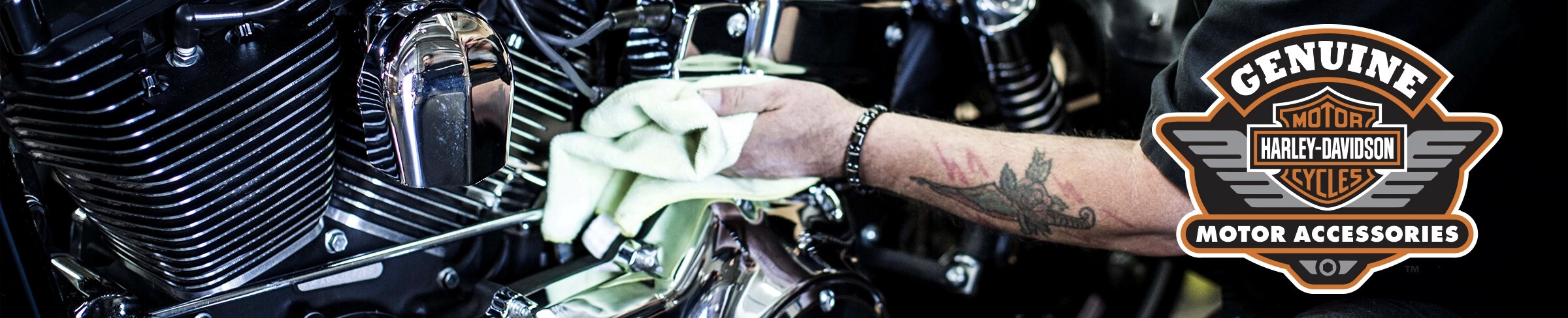A close up shot of a man cleaning his Harley-Davidson motorcycle