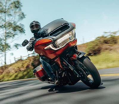 Harley Davidson bike riding away in a country screne