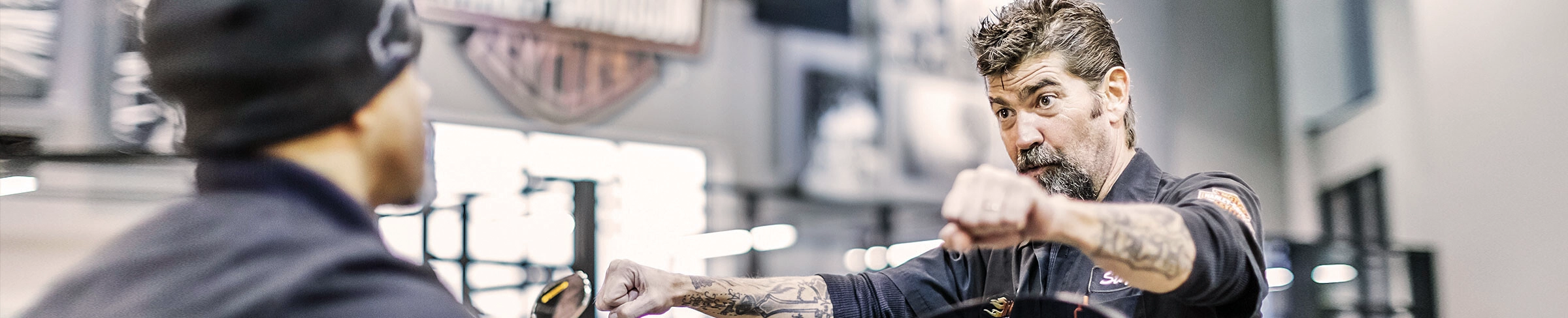 A Harley-Davidson worker speaking to a customer
