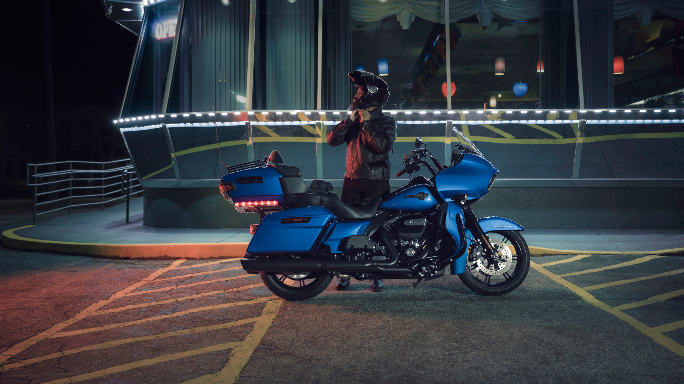 2024 Harley-Davidson® Road Glide® Limited in blue outside diner at night.