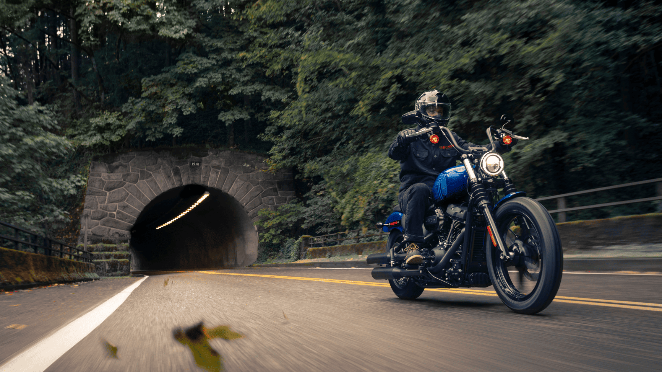2024 Harley-Davidson® Street Bob® 114 cruising out of a scenic tunnel ride
