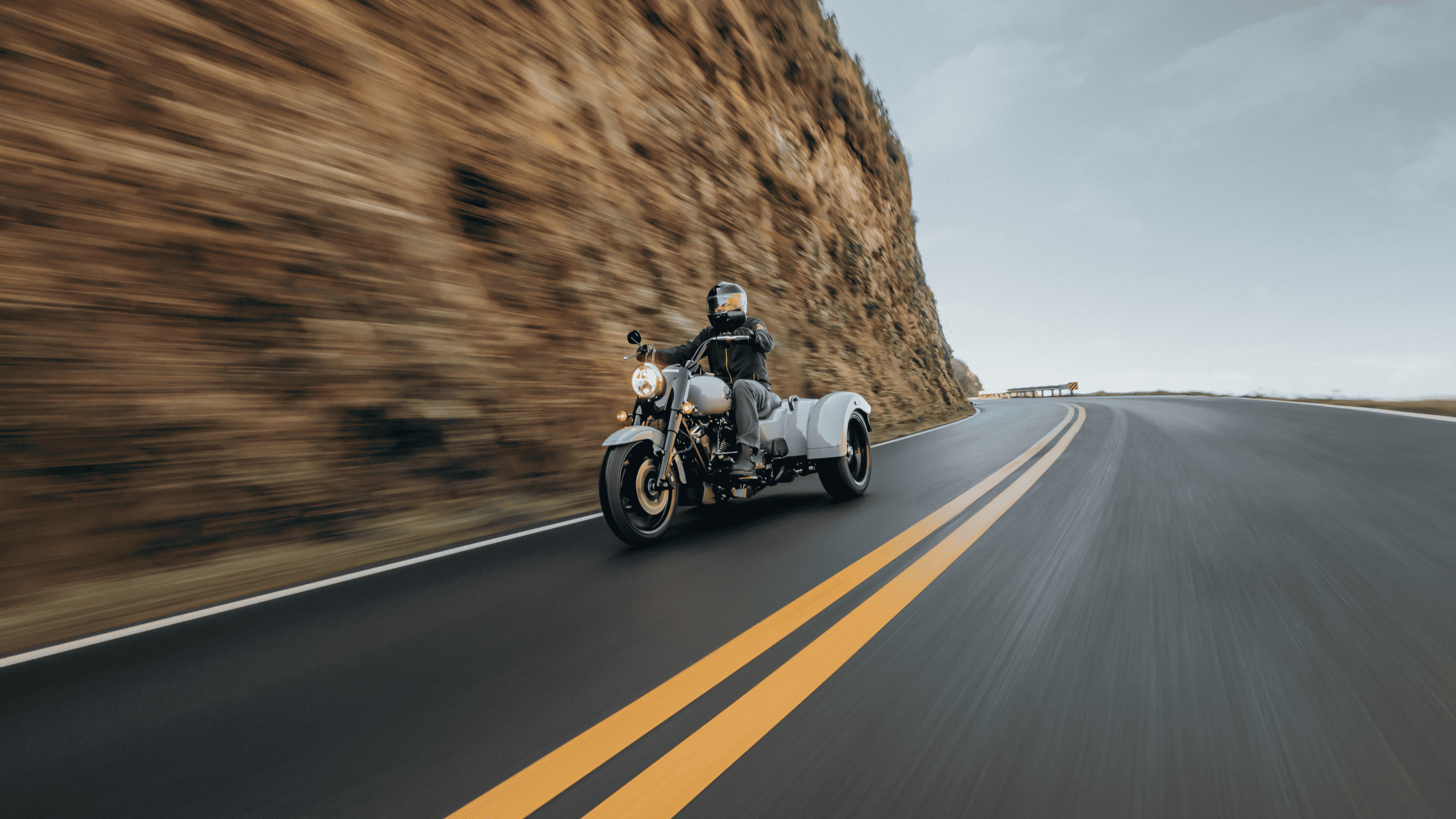 2024 Harley-Davidson® Freewheeler® cruising along scenic mountain highway