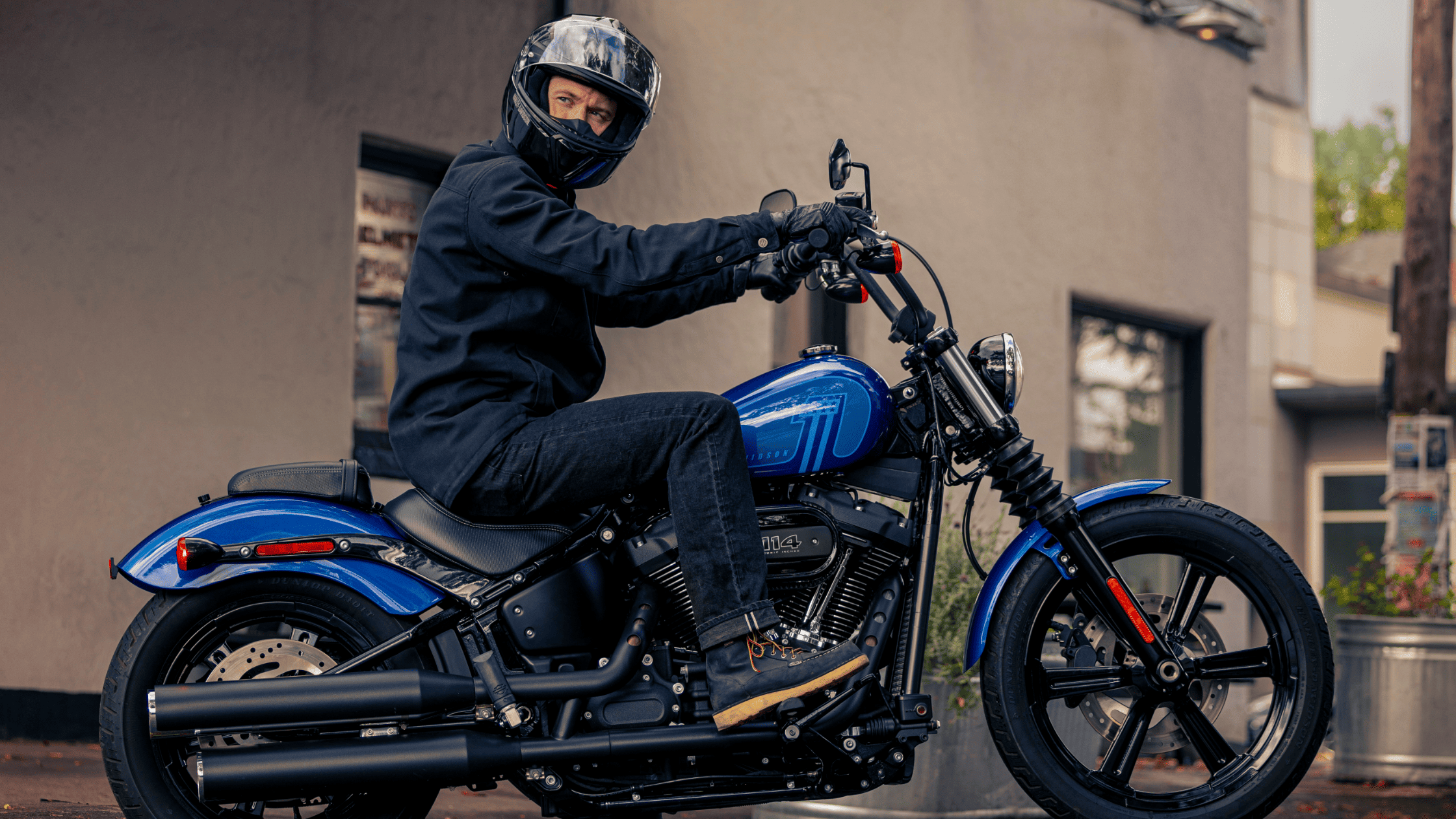 2024 Harley-Davidson® Street Bob® 114 rider ready in urban setting, blue model