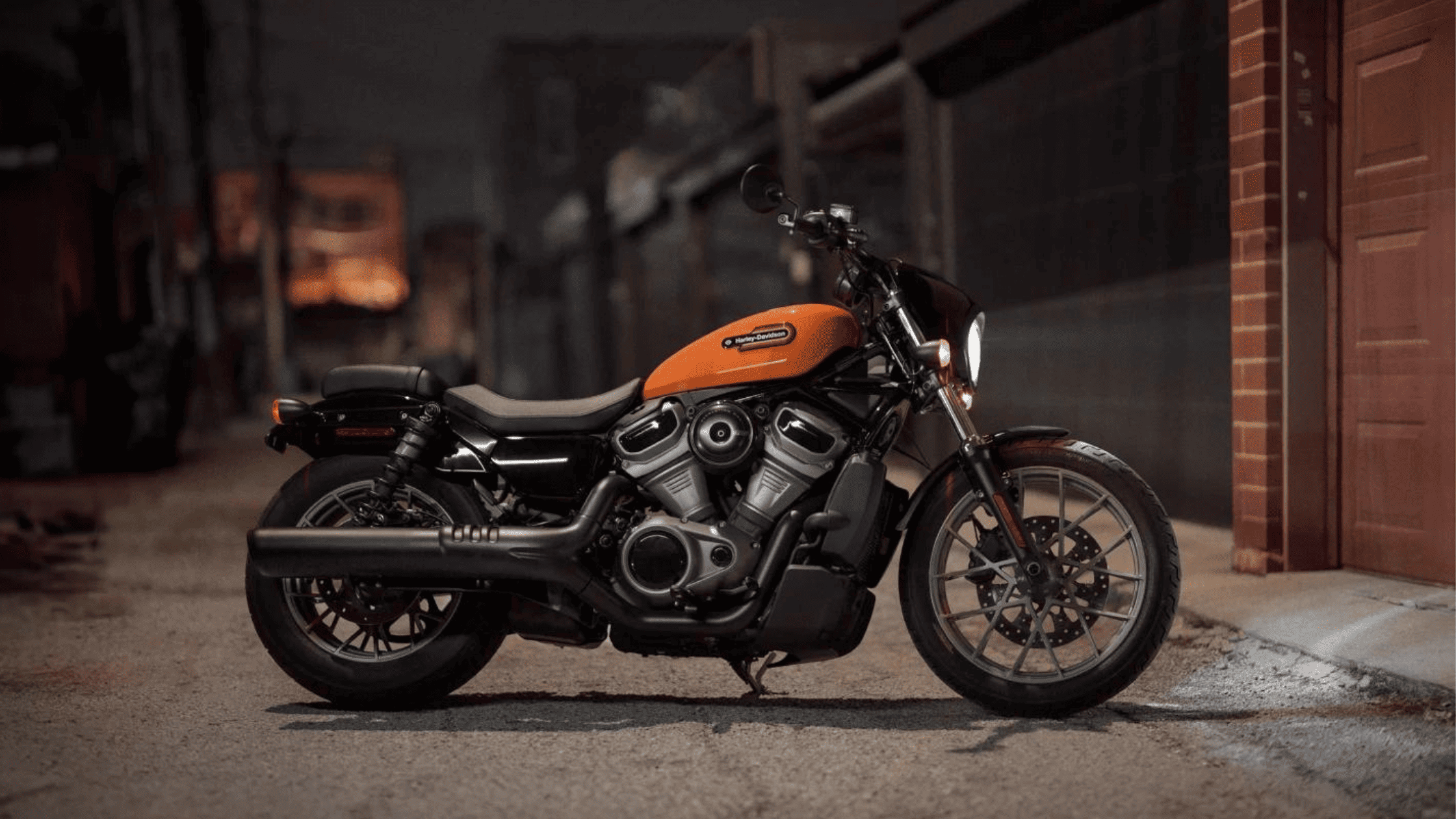 2024 Harley-Davidson® Nightster® Special in vibrant orange, night city setting