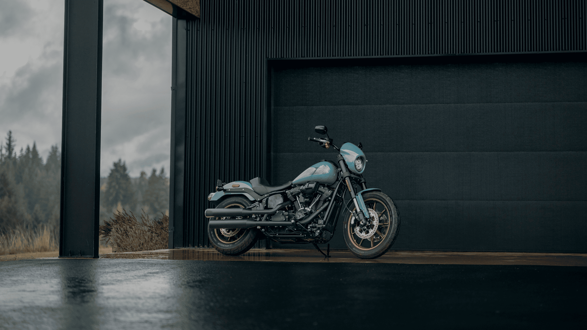 2024 Harley-Davidson® Low Rider® S in a striking blue finish, parked near a modern industrial building