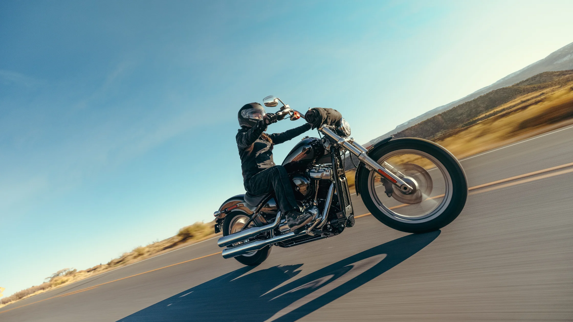 Rider enjoying an open highway on a 2024 Harley-Davidson® Softail® Standard.
