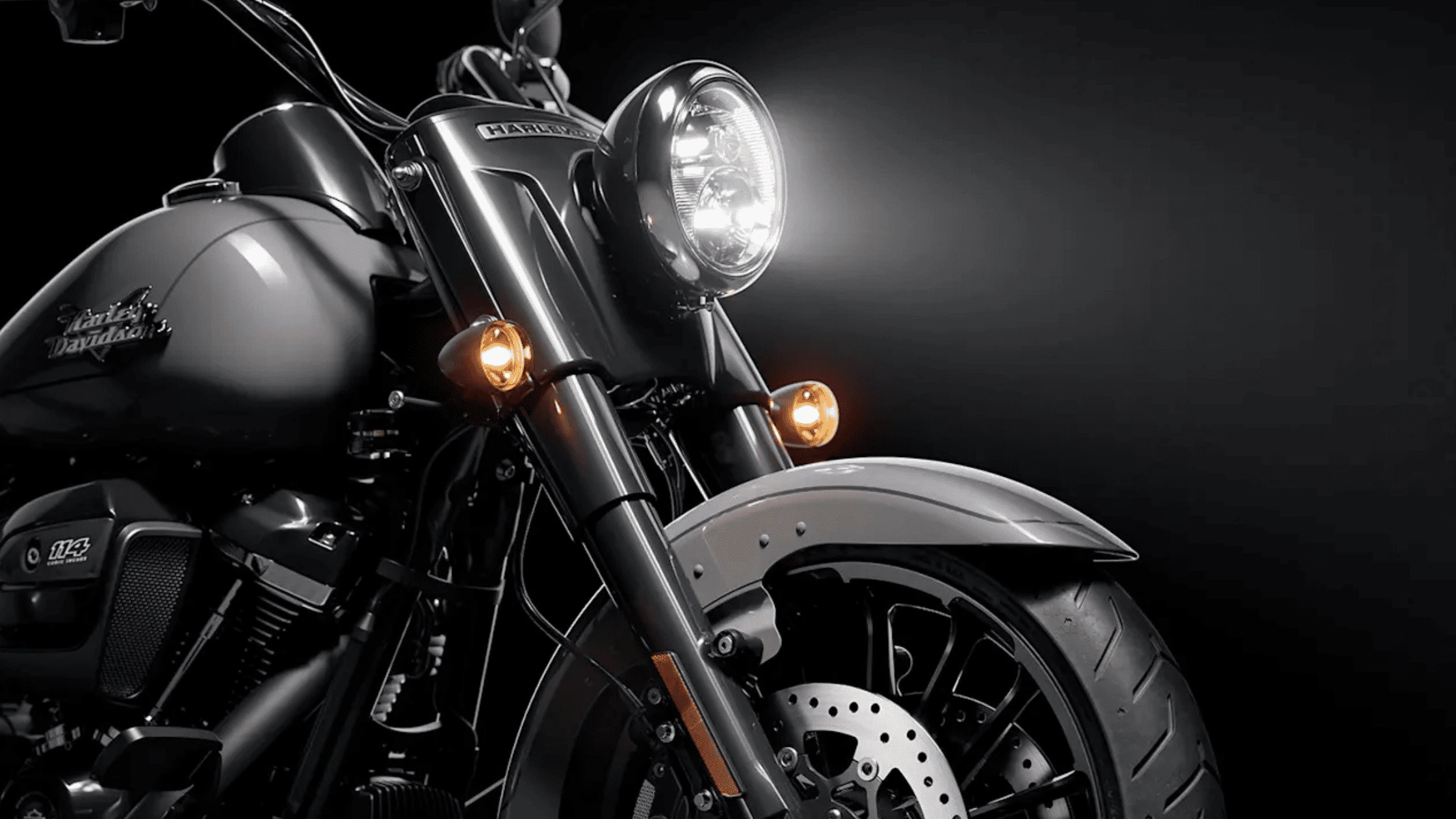Close-up of the 2025 Harley-Davidson® Freewheeler® with a sleek black design and illuminated headlights, showcasing premium craftsmanship near Bentonville, AR.