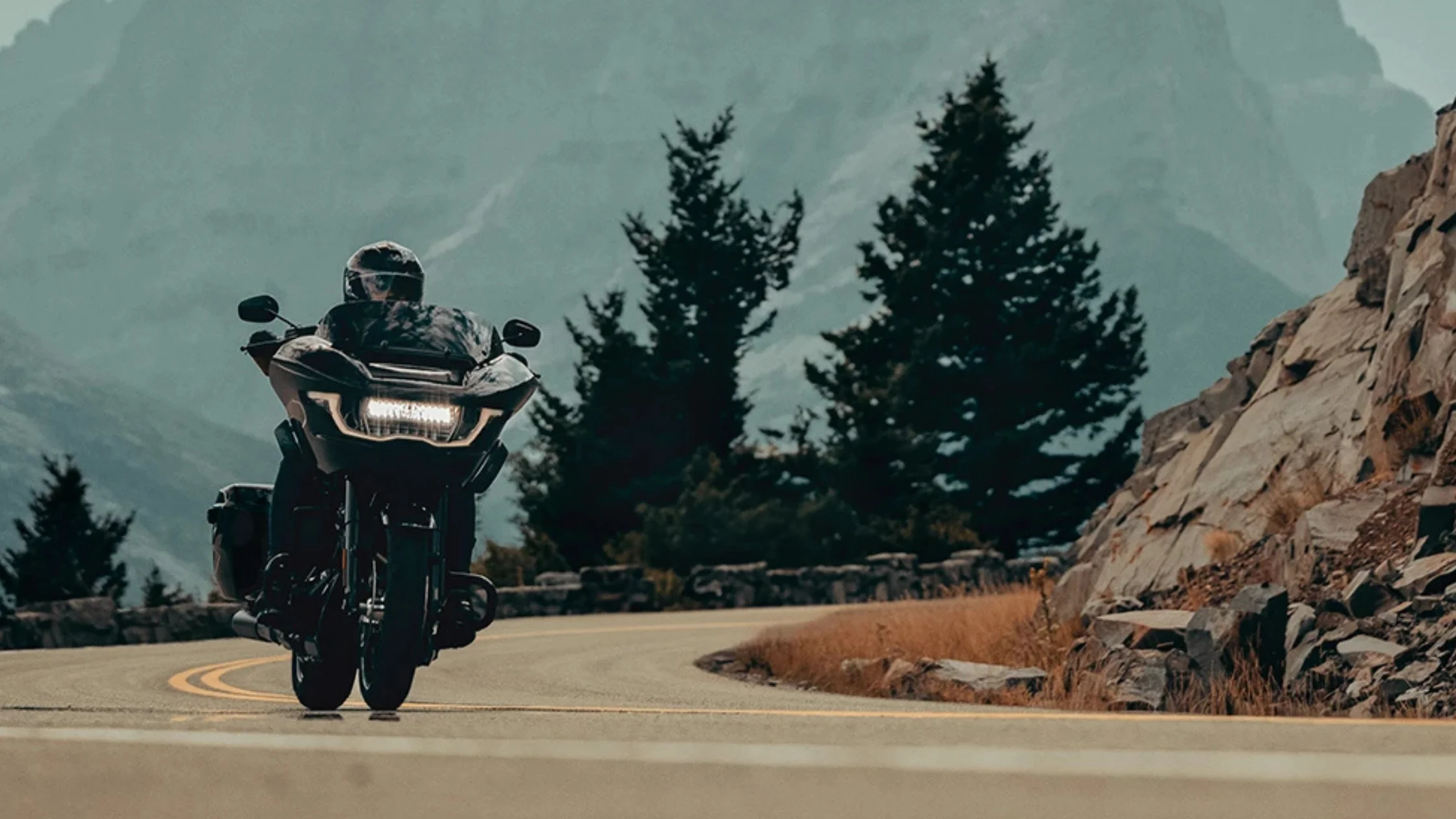 2025 Harley-Davidson Road Glide riding through winding mountain roads.