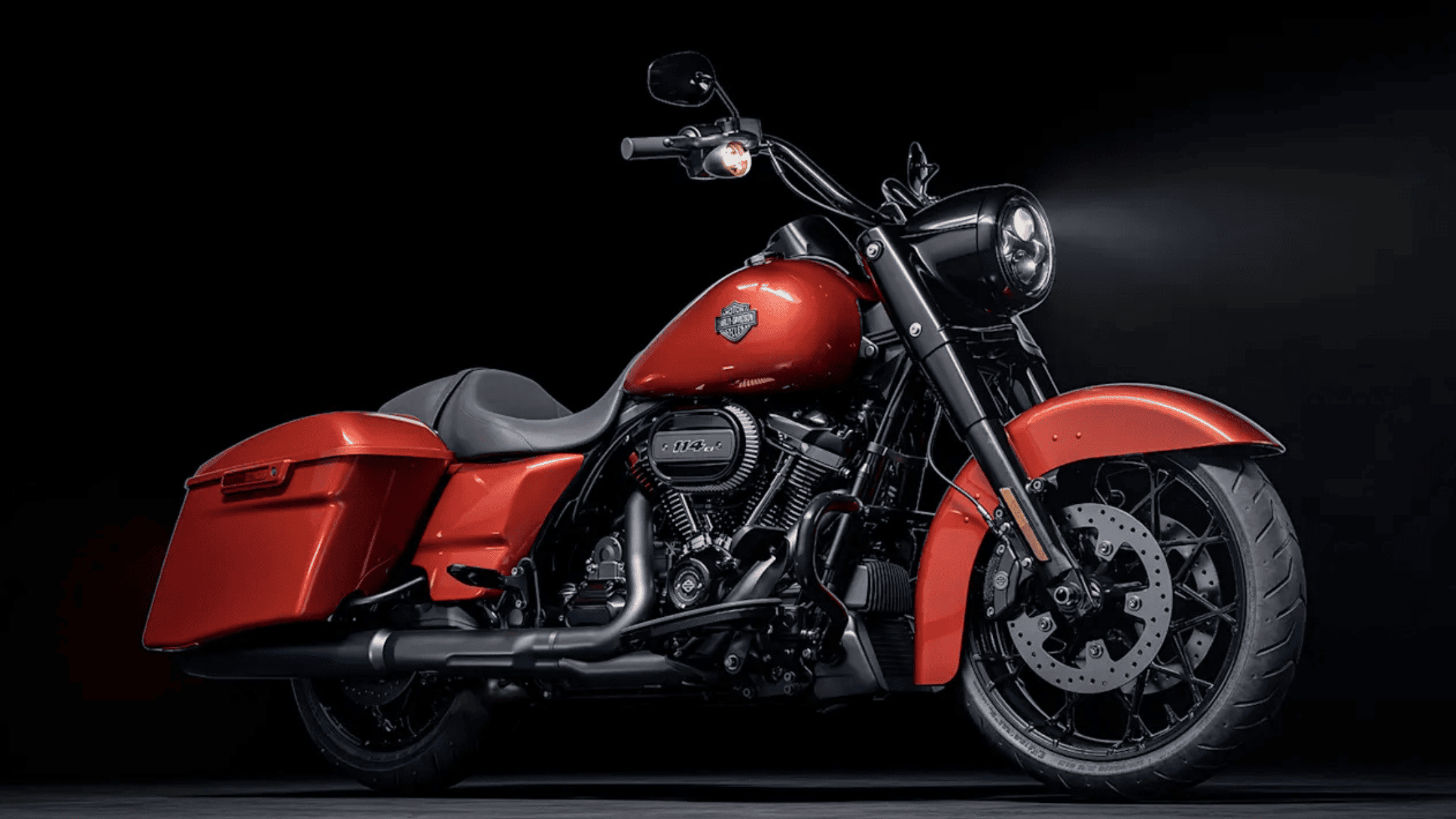A bold red 2025 Harley-Davidson® Road King® Special displayed under dramatic studio lighting