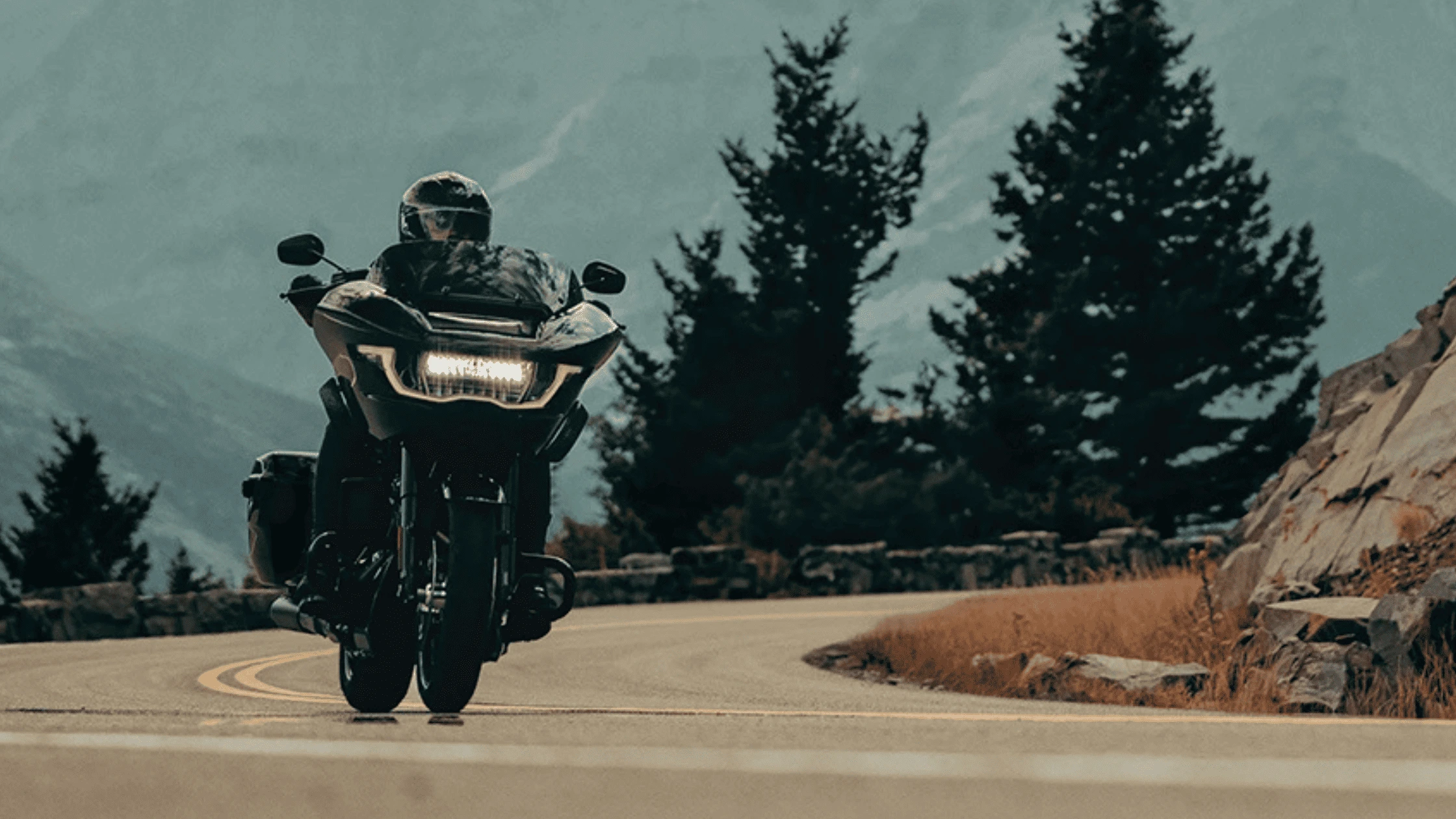 The 2025 Harley-Davidson® Road Glide® cruising on a scenic mountain road, designed for long-distance touring and unmatched comfort.