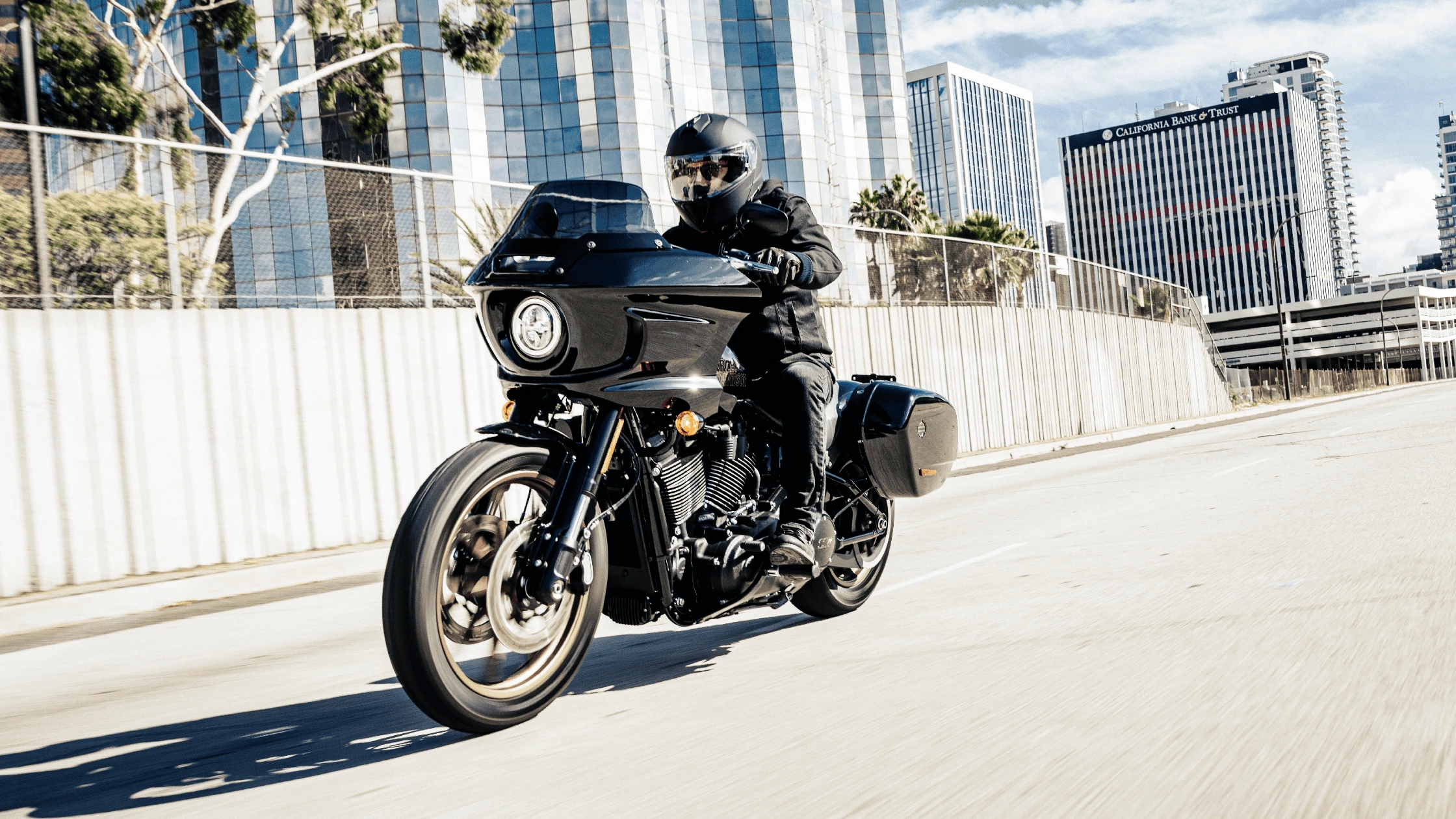 A rider cruising through the city streets on a 2024 Harley-Davidson® Low Rider® ST, highlighting its modern design and performance.