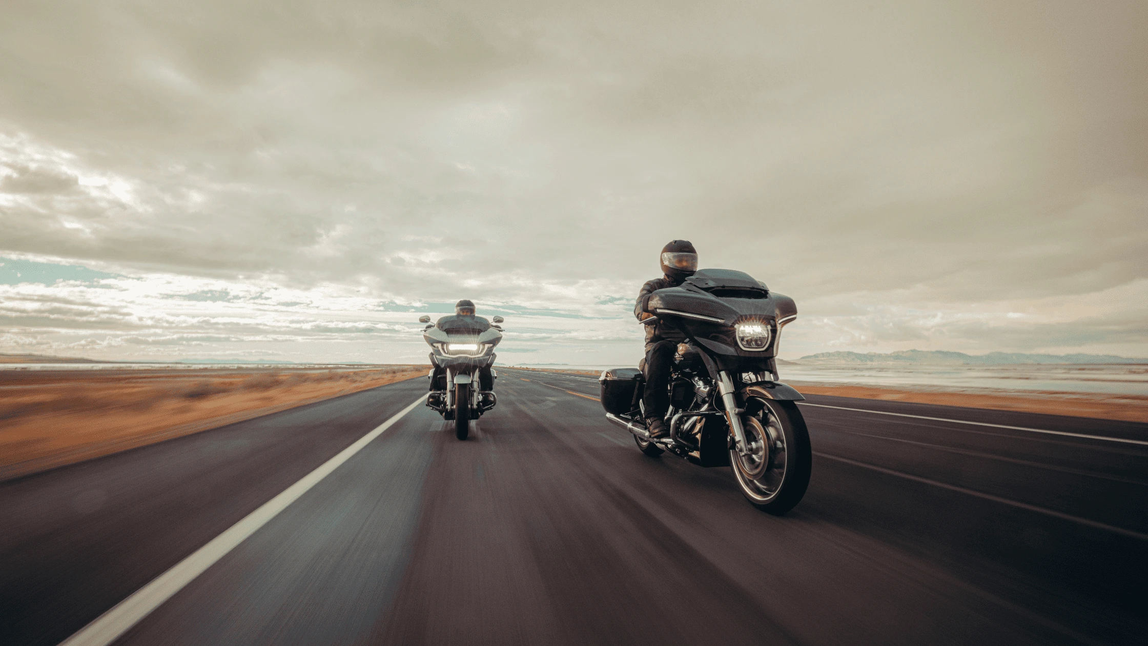2025 Harley-Davidson Grand American Touring motorcycles cruising down an open highway.