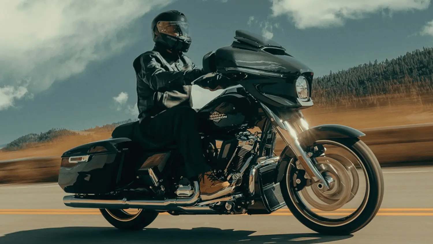 A motorcycle enthusiast riding a 2025 Harley-Davidson® Street Glide® on a sunny road in Stuart, FL.