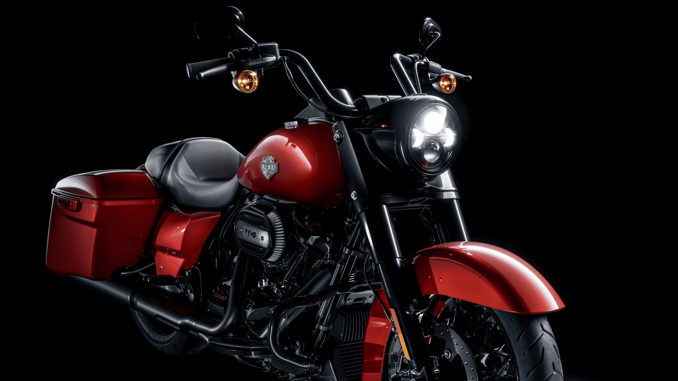 A bold red 2025 Harley-Davidson® Road King® Special is displayed against a black background, emphasizing its design