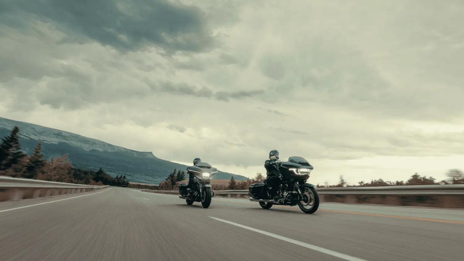 A pair of 2025 Harley-Davidson Grand American Touring motorcycles riding together on a sunny road in Stuart, FL.