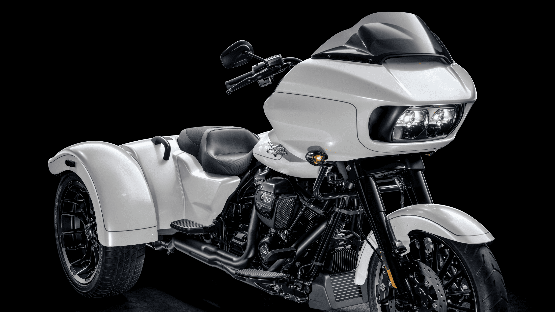 White trike motorcycle with a sleek design on a dark backdrop.