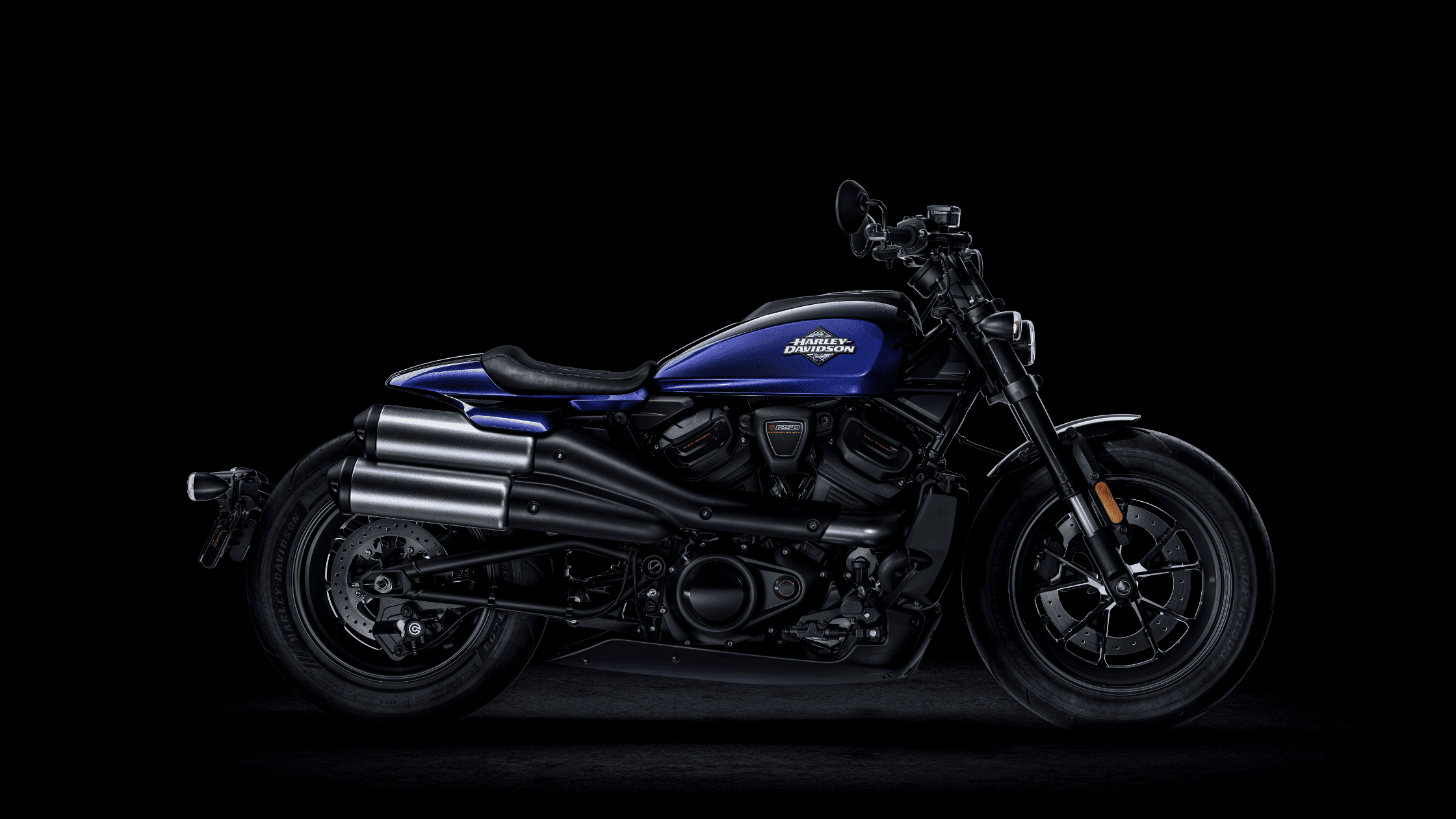 2025 Harley-Davidson® Sportster® S in deep blue, featuring a high-mounted exhaust, blacked-out engine, and aggressive stance.