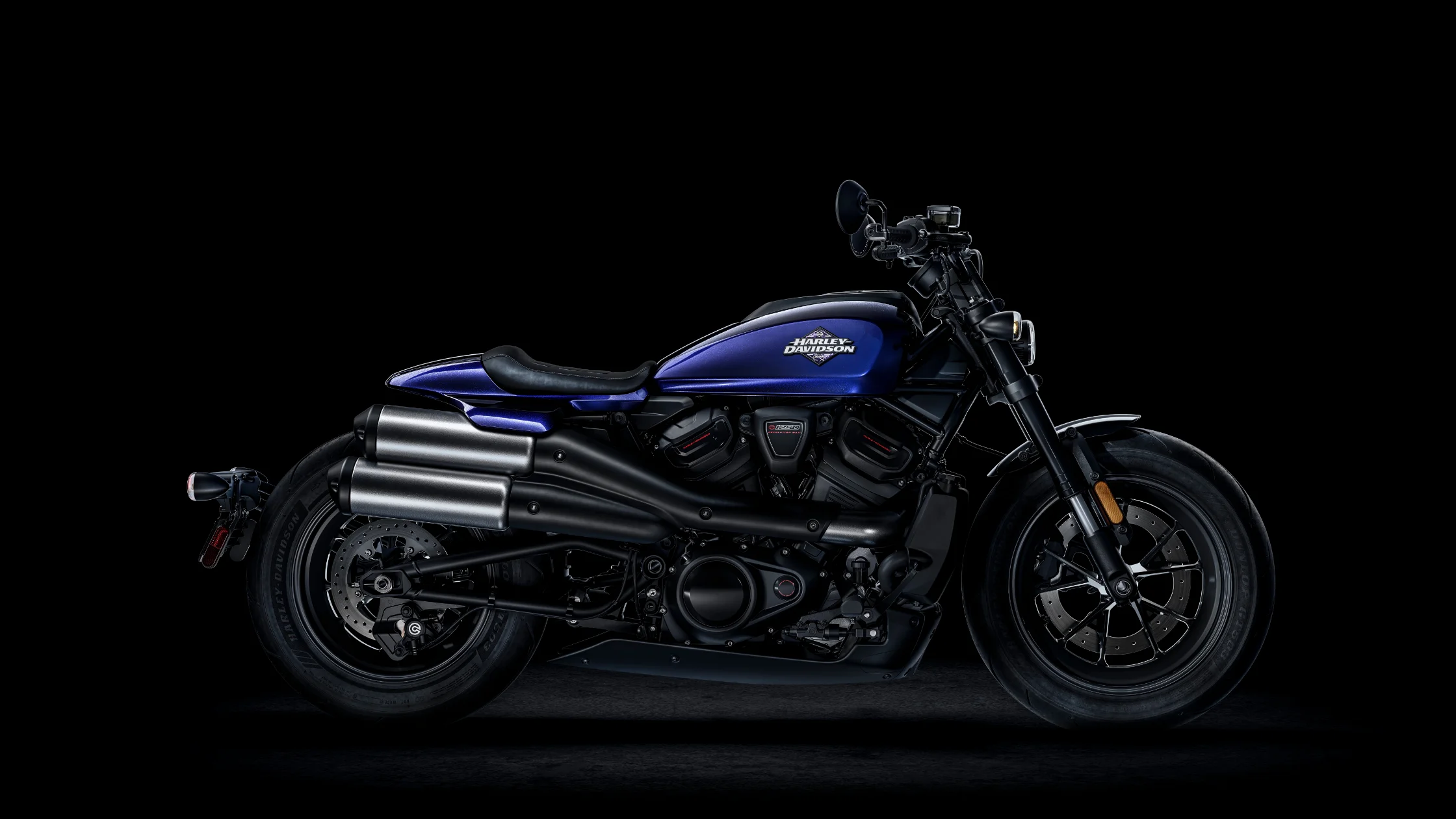 The 2025 Harley-Davidson Sportster S in a deep metallic blue finish, set against a dark background.