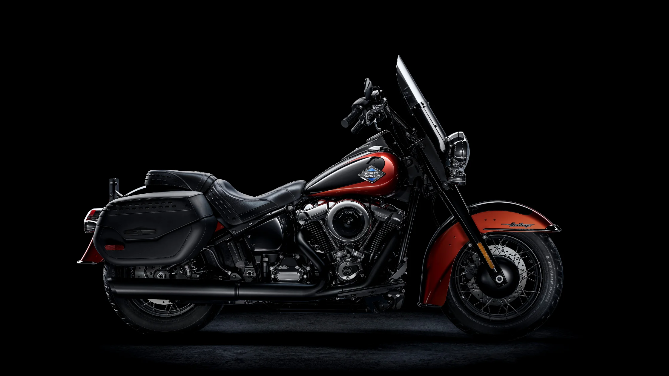 The 2025 Harley-Davidson Heritage Classic B in a striking black and burnt orange color scheme.