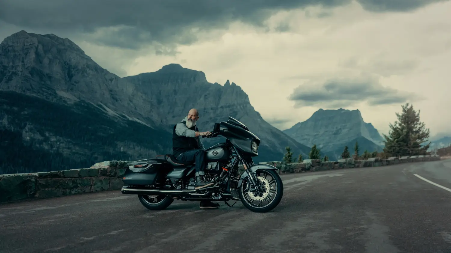 A motorcycle enthusiast rides a 2025 Harley-Davidson® CVO™ Street Glide® on a winding mountain road in Stuart, FL.