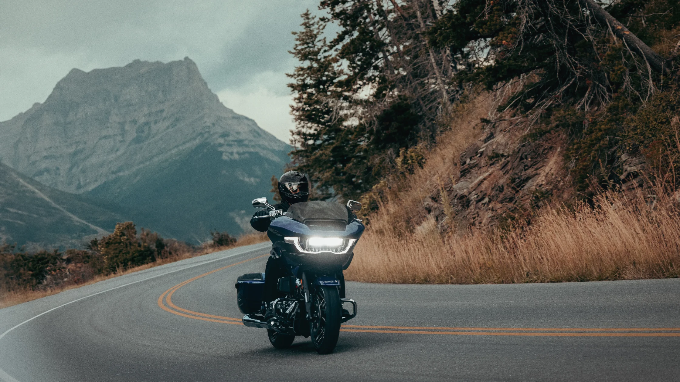 A motorcyclist navigates a winding mountain road on the 2025 Harley-Davidson® CVO™ Road Glide®.