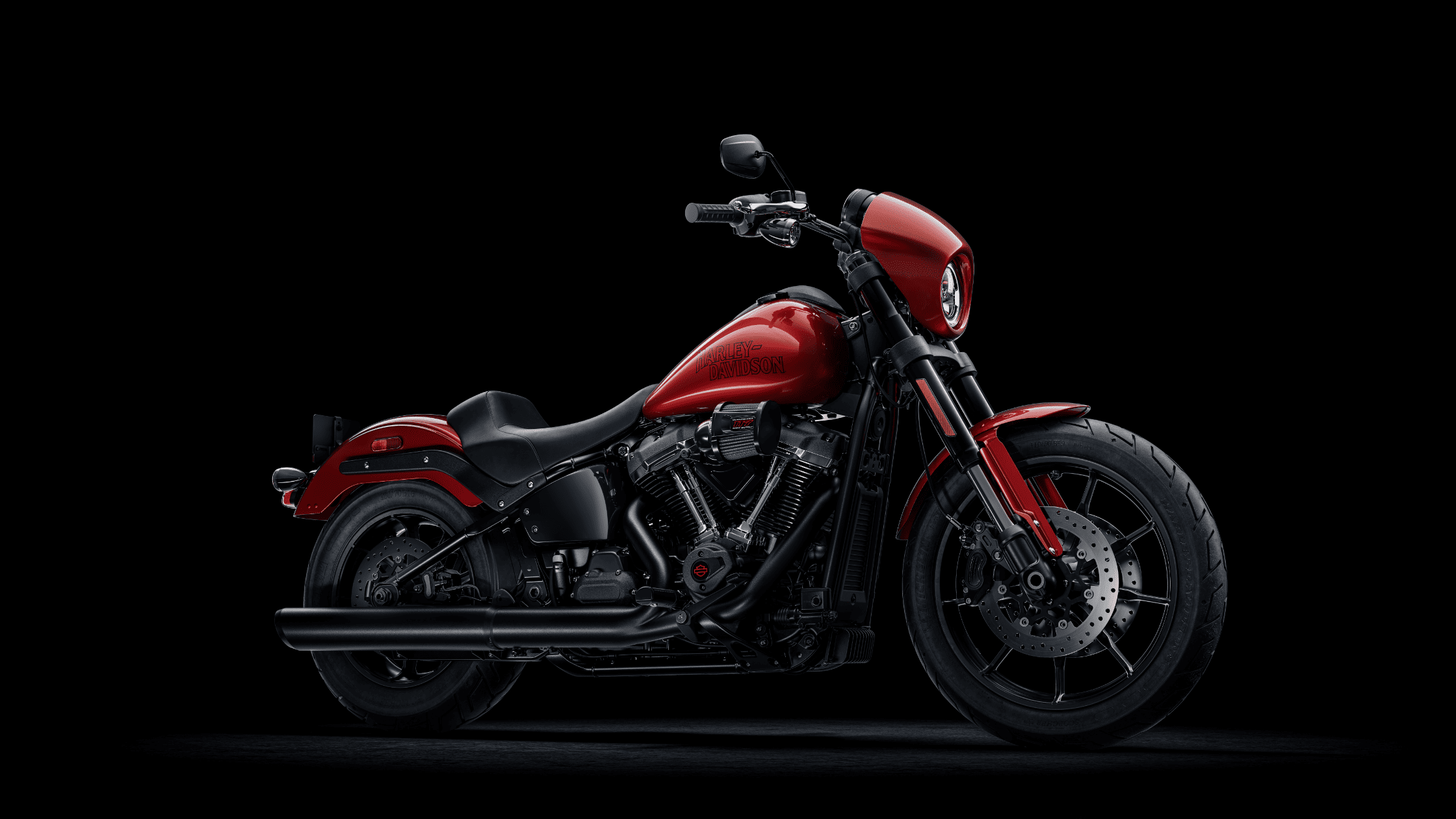 2025 Harley-Davidson Low Rider S motorcycle in glossy red with blacked-out engine and exhaust.