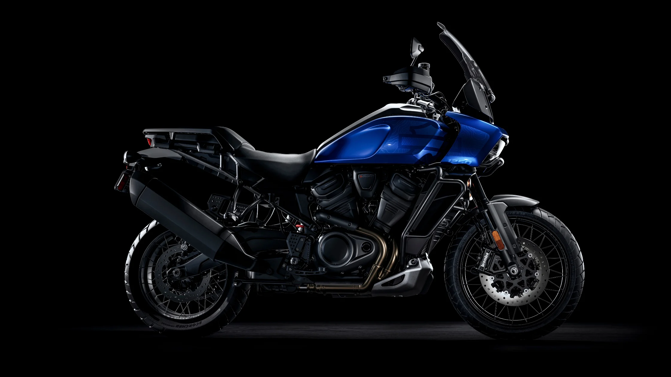 2025 Harley-Davidson® Pan America 1250 Special in blue, adventure bike on black backdrop